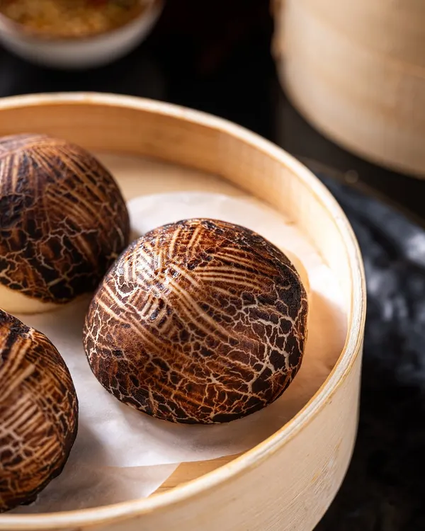 Our signature Mushroom Bao Buns are a work of art. The unique cracked pattern on the bun and the rich, earthy filling make for an unforgettable bite.