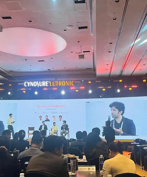 My work extends beyond the clinic to educating my peers. Here I am speaking at the Cynosure Lutronic APAC Summit, sharing my clinical experience and data on using advanced lasers for various conditions in Indian skin. Staying engaged with the global medical community ensures I bring the most current, evidence-based treatments back to my patients.