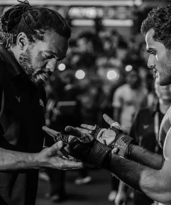 This is more than a sport. It's a bond forged in sweat and sacrifice. I am not just a coach, I am a mentor, and my fighters are my family. This moment, before the battle, is where we connect and remember everything we have worked for.