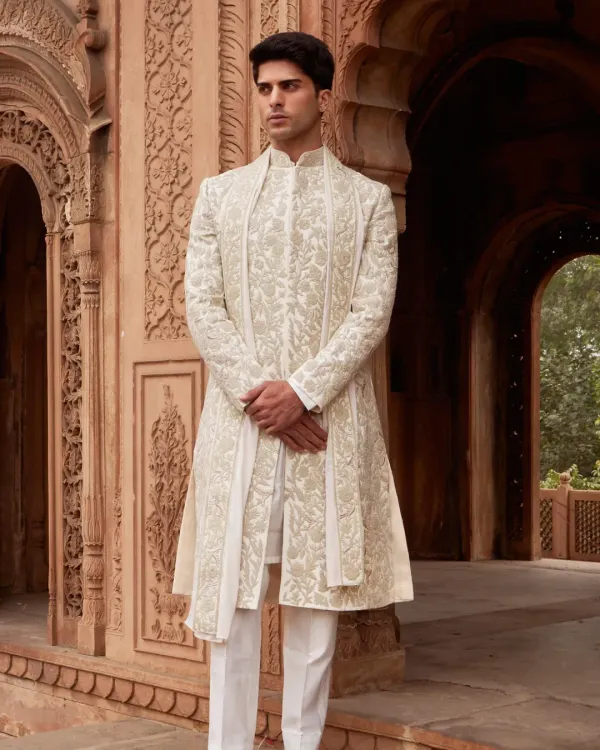 This hand embroidered ivory sherwani is the epitome of timeless elegance. I focus on impeccable tailoring and intricate, tone on tone detail to create a look of quiet luxury for your most important day.