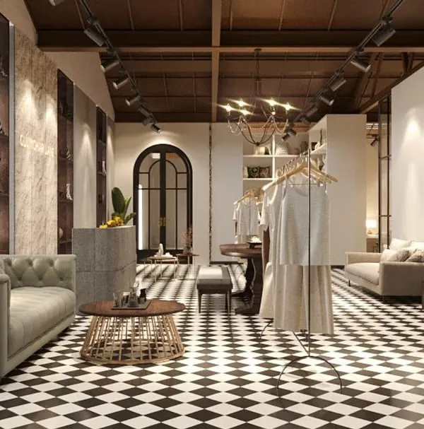 A rendering of the entrance area of the Gulmohar Lane store, featuring a classic black-and-white checkerboard floor. The space is set up like a grand foyer, immediately establishing a sense of home and elegance.