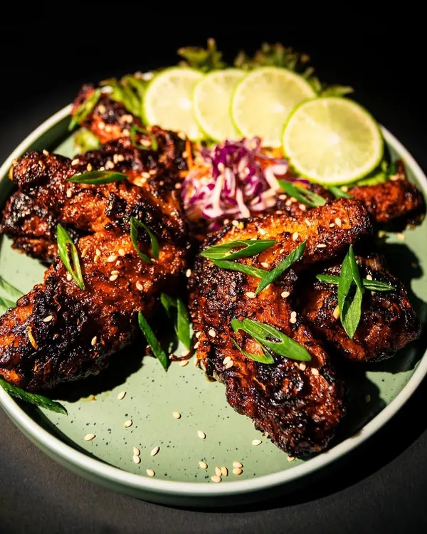 Our U-Morok Chicken Wings are not for the faint of heart. The deep, dark glaze comes from our special spicy sauce featuring the legendary King Chilli, giving the tender wings a smoky and intense heat. Served with fresh lime and a cooling slaw.