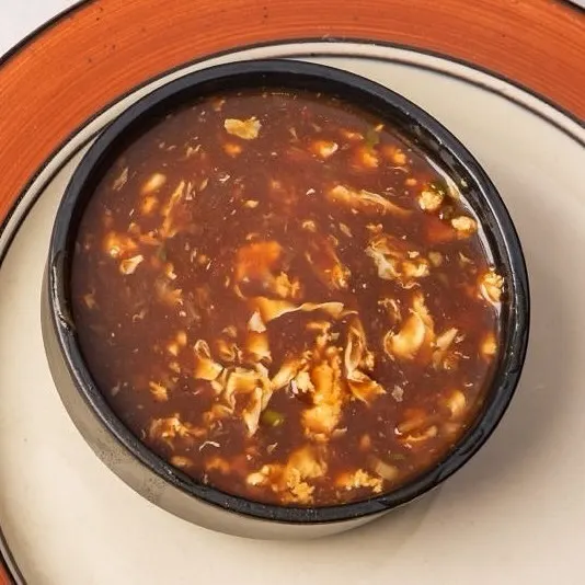 The Manchow Soup is a popular Indo-Chinese soup. It's a spicy and savoury soup filled with vegetables and topped with crispy fried noodles.