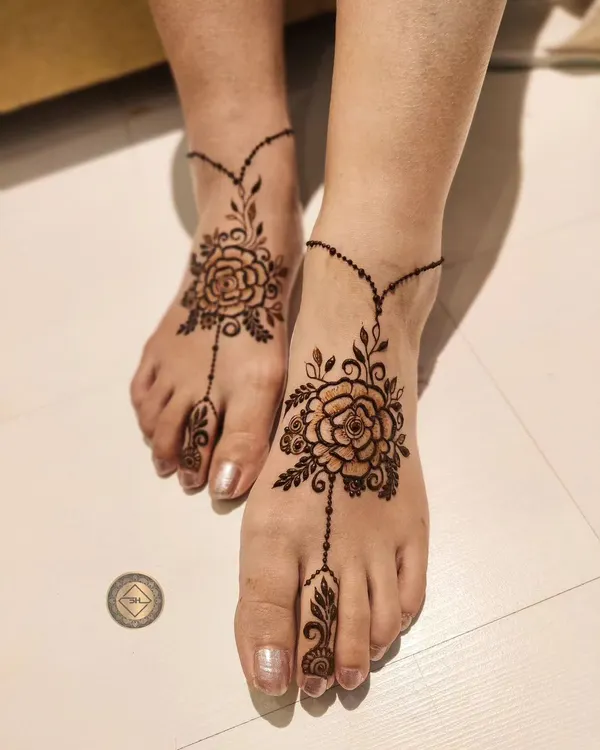 Henna isn't just for hands. This is a simple and beautiful floral design for the feet, connecting from the ankle to the toe like a delicate piece of jewelry.