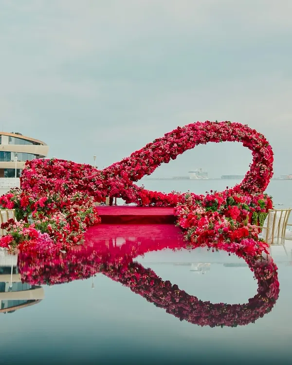A breathtaking infinity-shaped floral mandap set against the serene backdrop of the Persian Gulf in Doha. This design symbolizes endless love and showcases our ability to create grand, iconic structures in stunning destination locations.