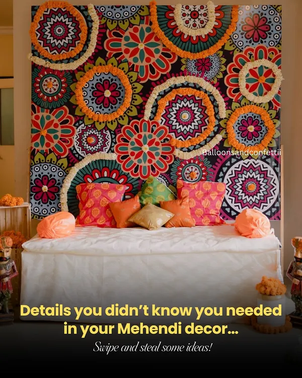 This is the vibe I love to create for a Mehendi. It’s all about those little details, like the vibrant printed backdrop layered with fresh marigold and tuberose garlands, and the colorful cushions that make the seating pop. This setup is designed to be the perfect, lively photo corner for the bride and her friends.