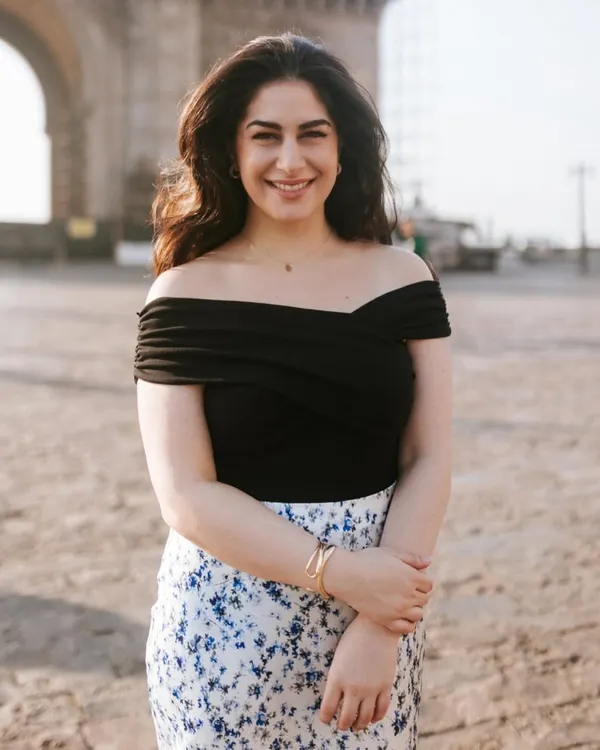 A warm, welcoming portrait taken at the Gateway of India. The soft morning light and her friendly smile make this a perfect shot for a personal or professional profile.