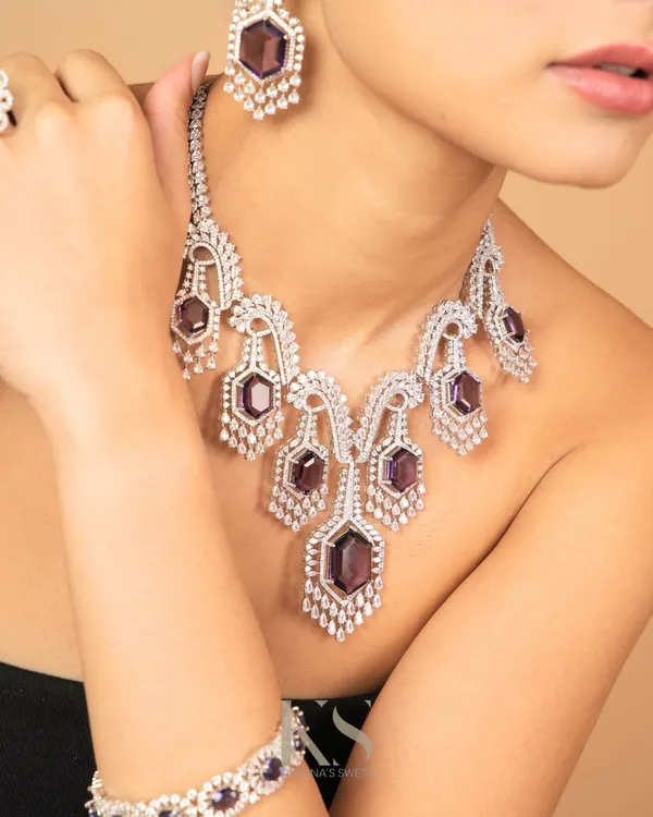 A full look at our American Diamond necklace set with amethyst-colored stones. The set includes a matching bracelet, offering a complete, coordinated look for a modern event.