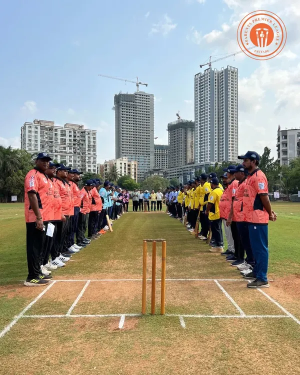 Two teams in vibrant jerseys line up on the pitch, ready for the start of a Parents Premier League match at our Kandivali ground. This image captures the professional setup and buzzing atmosphere of our community tournaments.