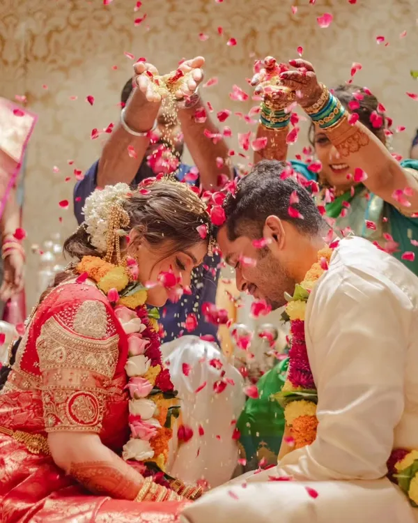 A beautiful, emotional moment from a wedding ceremony, with the couple being showered in flowers. It's moments like these that make everything worthwhile.