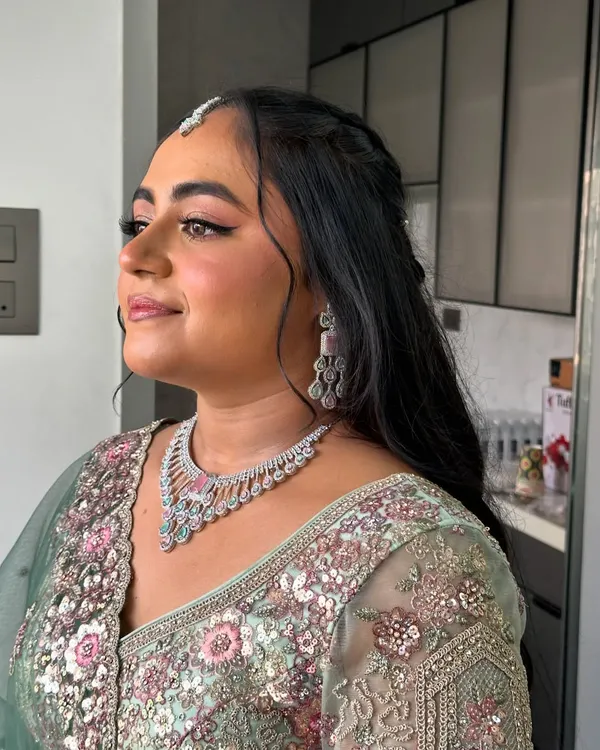 Vrushali looking absolutely radiant for her engagement. We went for a soft glam look with a focus on glowing skin and beautifully defined eyes to complement her pastel green lehenga.
