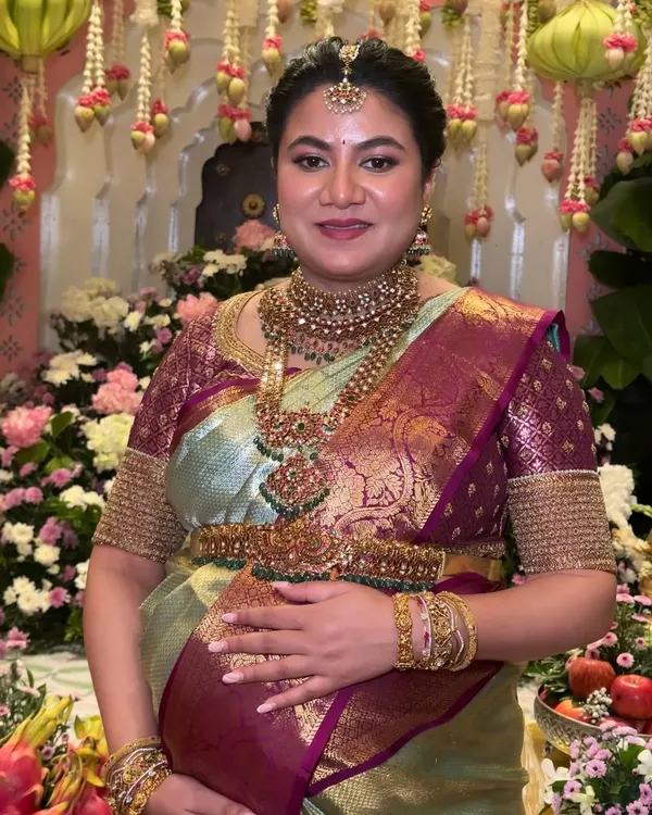 A radiant and traditional makeup look for a beautiful mom-to-be at her Seemantham ceremony. The focus is on glowing skin and defined features that perfectly complement her silk saree and temple jewelry.