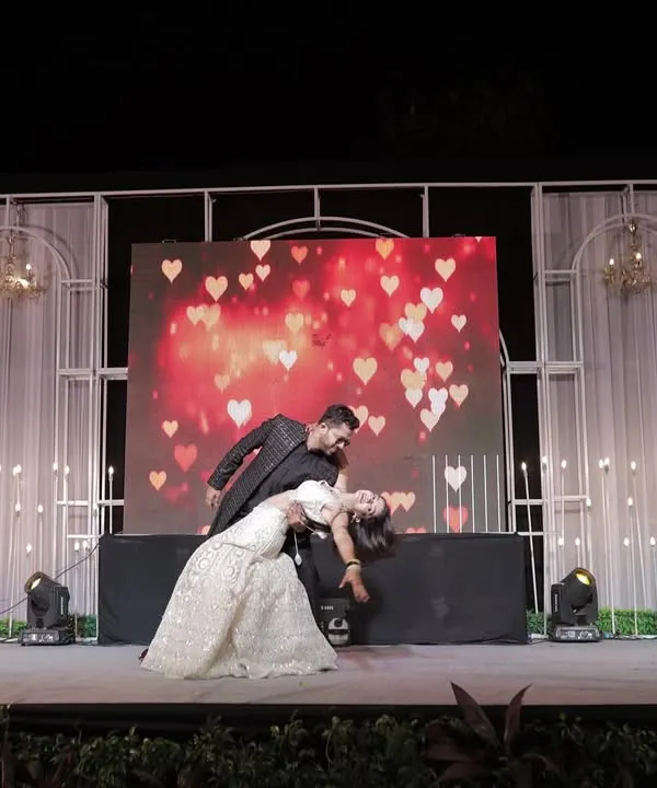 The classic dance dip! We love capturing the peak moments of a couple's Sangeet performance against a beautifully lit stage.