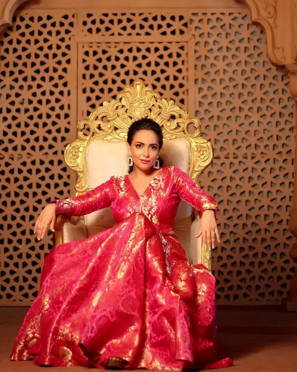 A regal portrait of Aanchal Munjal for a Diwali shoot. The makeup is luminous and festive, with a pulled-back hairstyle that keeps the focus on her radiant face and the stunning pink brocade outfit.