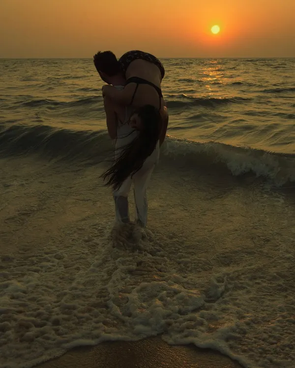 A classic moment from a sunset engagement shoot, with the warm light of the setting sun creating a beautiful silhouette. This is the kind of cinematic couples photography I love to create by the sea.
