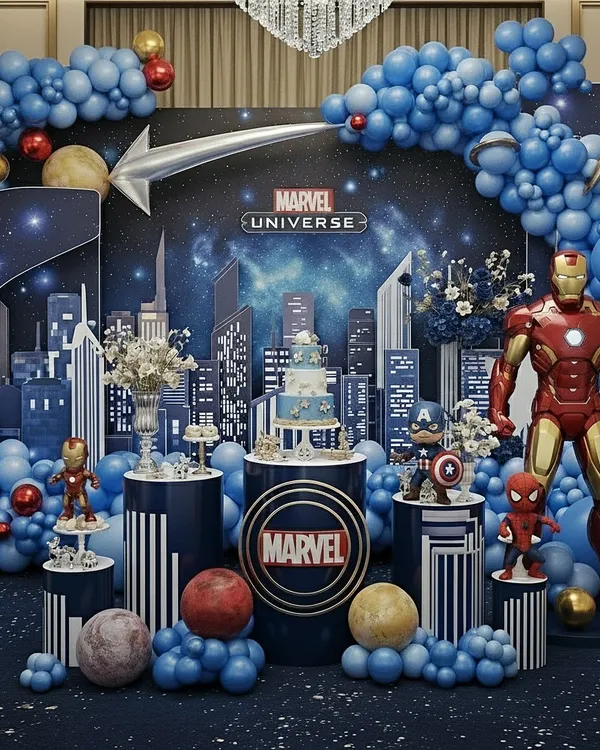 This is the complete Marvel Universe stage, featuring a dynamic cityscape backdrop and a massive balloon arch. Life-size Iron Man, Captain America, and Spider-Man figures stand guard over the cake, creating an epic scene for a young fan.