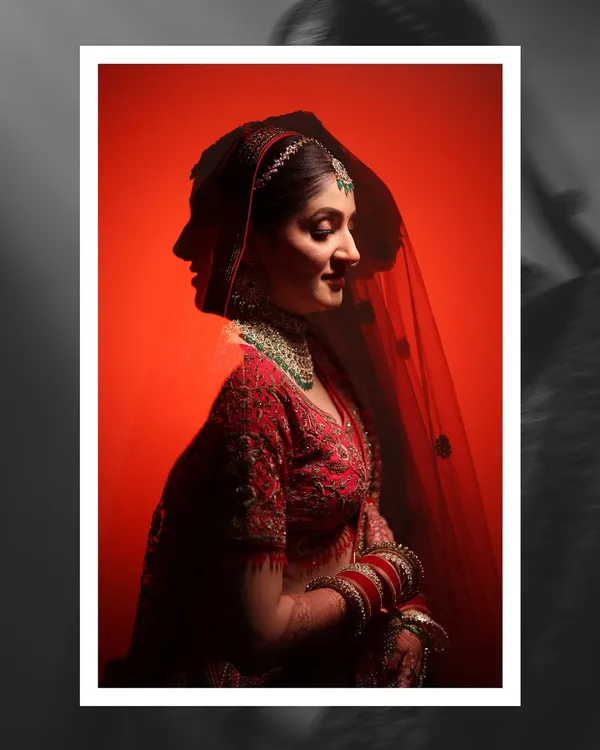 An artistic double exposure bridal portrait against a bold red background. This creative shot blends the bride's profile with a forward-facing view, creating a unique and captivating image.