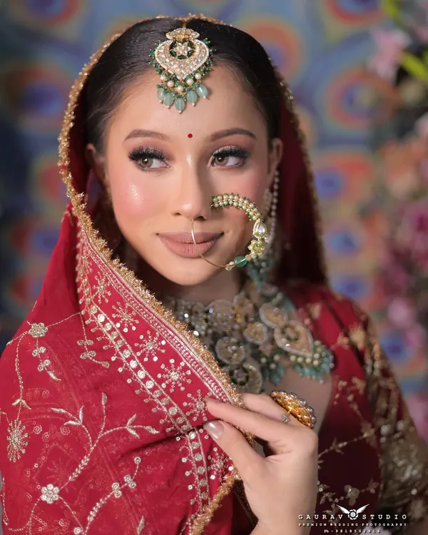 A classic bridal portrait focusing on the intricate details of the makeup and jewelry. I ensure every element, from the shimmer on the eyelid to the design of the nath, is captured with perfect clarity.