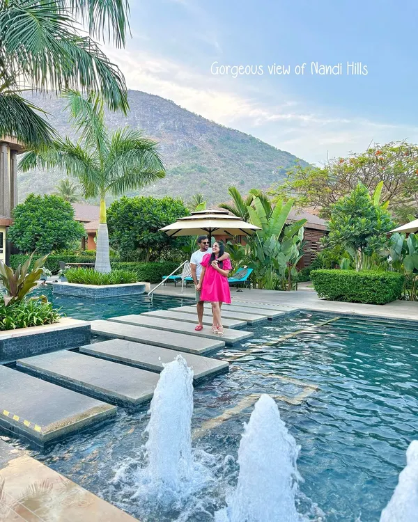 A couple enjoys the stunning view of Nandi Hills from across our pool. The stepping stones over the water create a picturesque path, perfectly framing the natural landscape that makes this retreat so special.