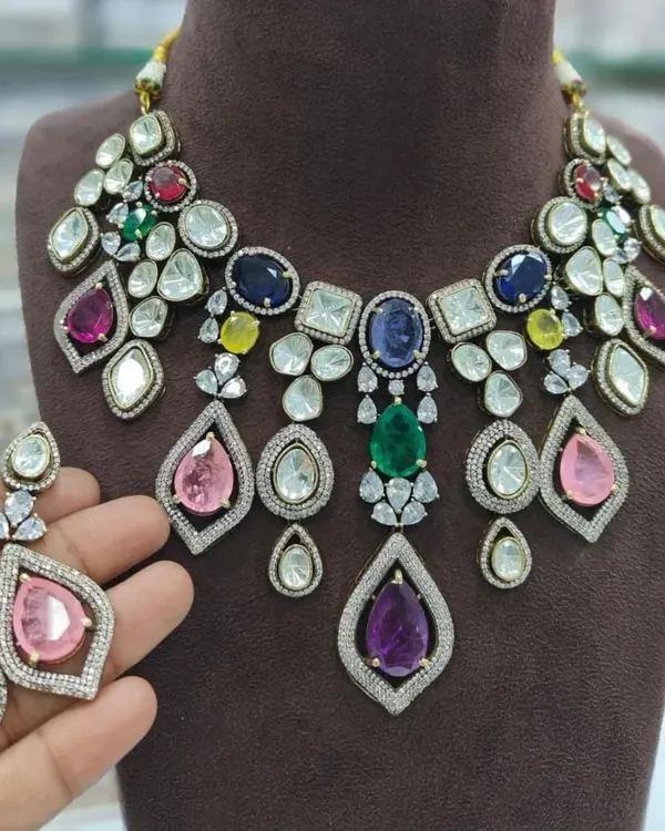 A stunning multi-color necklace set perfect for a sangeet or reception. This rental piece features a mix of colorful stones and uncut Polki, making it a vibrant and eye-catching choice.