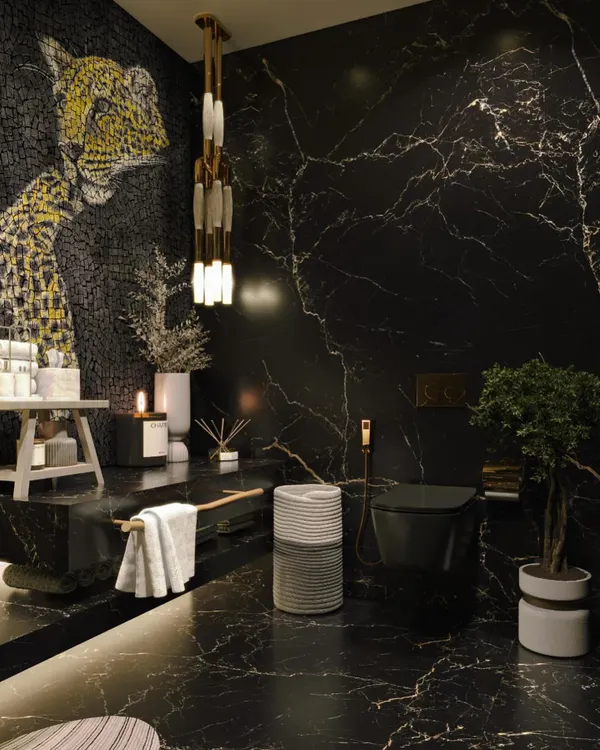 Another angle of the bold powder room, highlighting the expanse of the black Marquina marble on the walls and floor. This view shows the modern black toilet and the continuation of the dramatic, luxurious theme.
