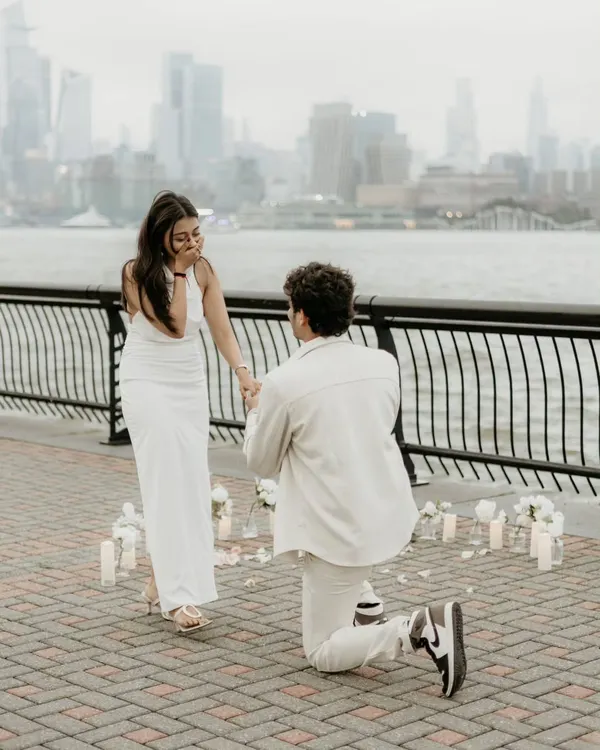 This is it. The moment the world stops. I worked with Monil to plan this surprise down to the second, hiding to capture that pure, unfiltered shock on Vishruti's face. Capturing this split-second of raw emotion against the New York skyline is what I live for.