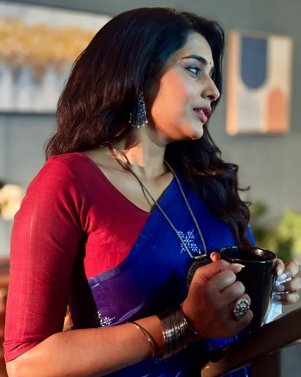 A profile shot of the actress on set, showcasing how the makeup holds up from every angle. The soft contouring and natural lip color define her features for the camera.