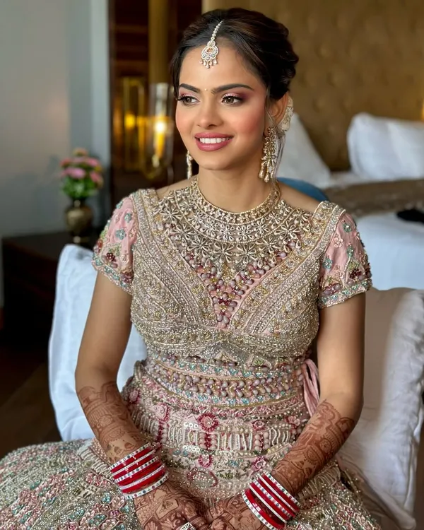 This is the essence of my signature soft glam bridal look. I focused on creating luminous, healthy-looking skin and enhancing her features with a palette of soft pinks, letting her joyful smile be the main event.