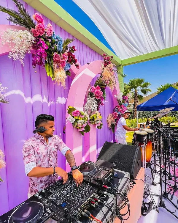 A clear view of my DJ and percussionist setup at a beautiful outdoor wedding function. The combination of my mixing and live drumming creates a full, dynamic sound perfect for daytime celebrations.