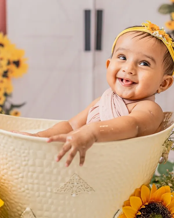 A cheeky grin from the tub. This sunflower-themed milk bath session was so much fun, and she absolutely loved splashing around.
