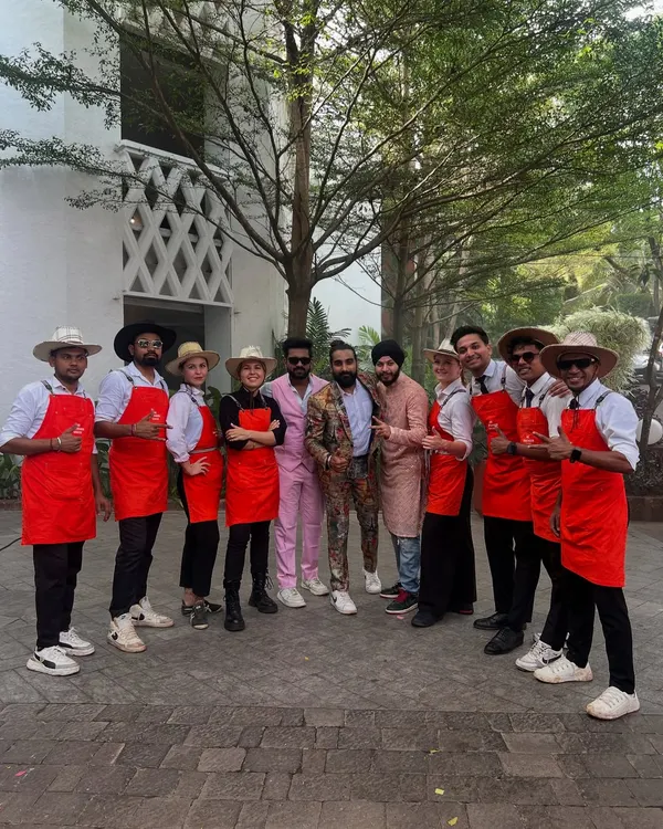Meet the squad! Our team, dressed in themed red aprons and hats, posing with the happy clients. We are more than bartenders; we are part of your celebration.