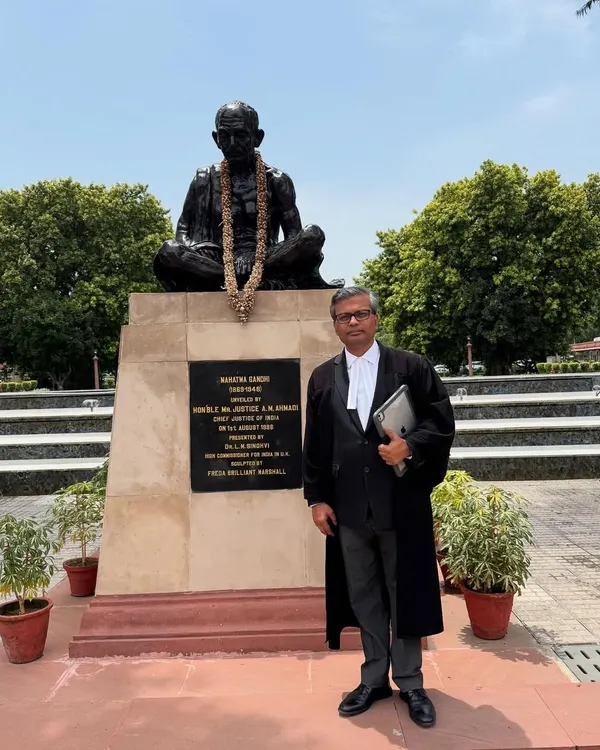 After seventeen years of practice, standing before the statue of Mahatma Gandhi on the Supreme Court premises, a place that symbolizes the pursuit of justice.