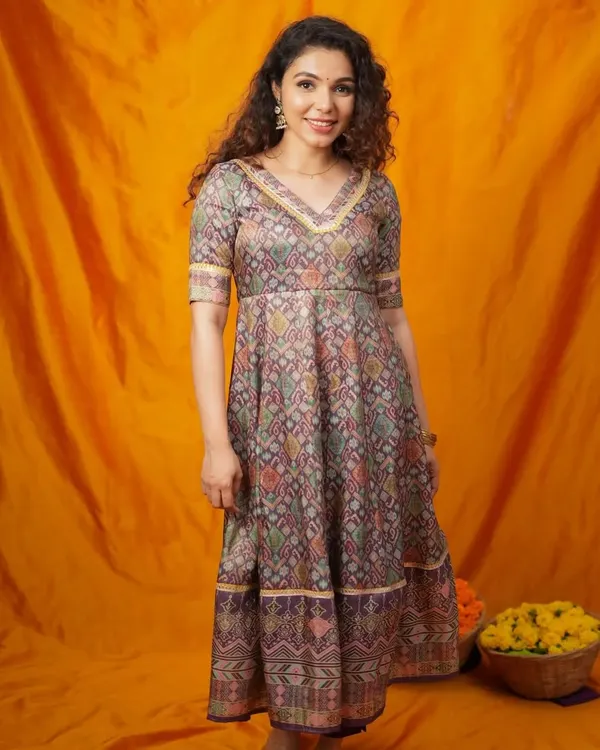 A beautiful Anarkali-style dress with a traditional Patola print. This tiered design has a lovely flare and can be adapted for a comfortable and flattering plus-size fit.