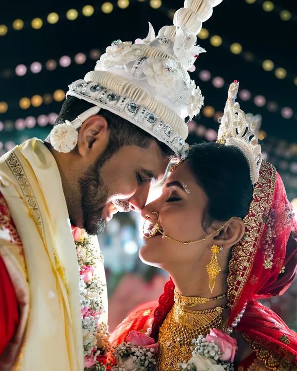 This is the magic we live for. The quiet moment between a bride and groom, full of love and anticipation, captured during a beautiful Bengali wedding ceremony.