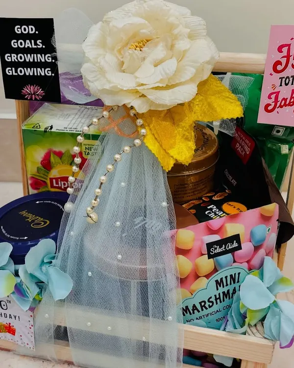Celebrating a golden milestone. We curated this "Fifty & Totally Fabulous" hamper for a 50th birthday, filling a wooden crate with tea, chocolates, marshmallows, and other delightful treats.