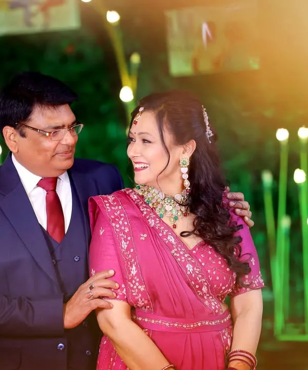 A candid, happy moment between the couple celebrating their 25th anniversary. The warm lighting and their natural smiles make this a perfect memory.