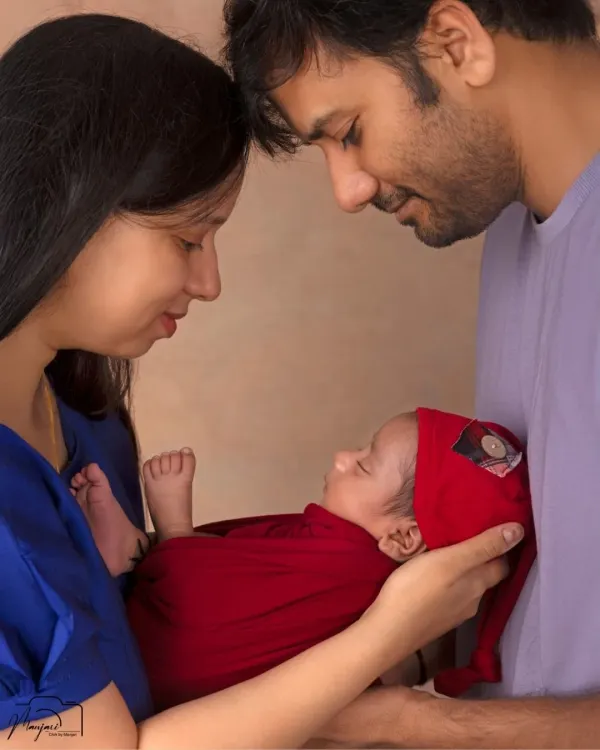 The three of you, together at last. This classic family pose captures the beginning of your new life, with your little one held securely in your loving arms.