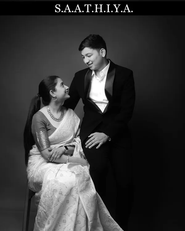 A classic black and white pre-wedding portrait with the word "Saathiya," meaning companion. This style adds a timeless, cinematic feel to your love story.