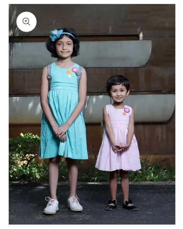 Here you can see how my crochet flower patches look on children's dresses. The patches add a charming, handmade detail to simple outfits, making them unique and special.