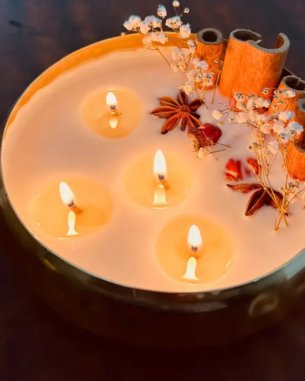 This is one of my favorite creations, a premium 6-inch metal urli candle. I've adorned it with real dried flowers and spices like cinnamon and star anise. It creates such a warm, luxurious glow and is perfect for making any space feel special, especially during festivals.