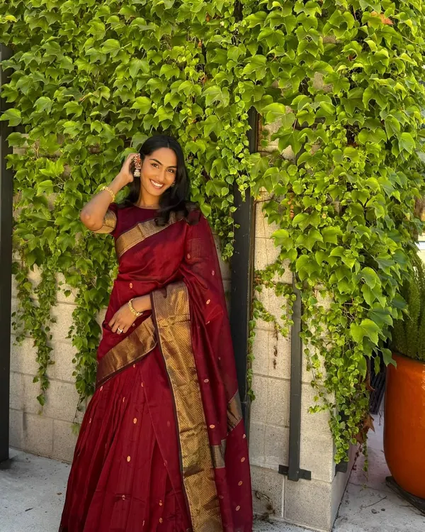 A happy client, Rishika from the USA, looking stunning in our viral maroon half saree. A testament to our global reach and personalized service.
