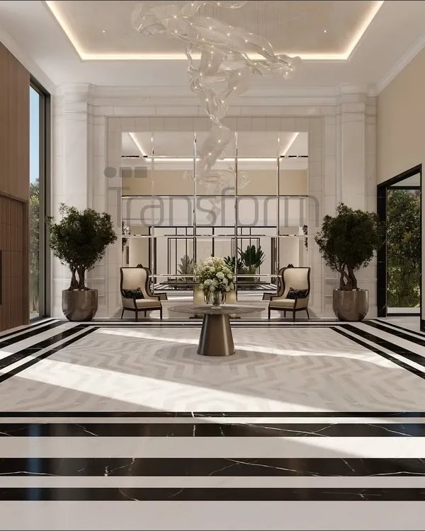 In this foyer, I used a bold black and white marble floor to create a sense of contemporary luxury. The large mirror reflects the open courtyard, extending the home's elegance and creating a boundless sense of space.