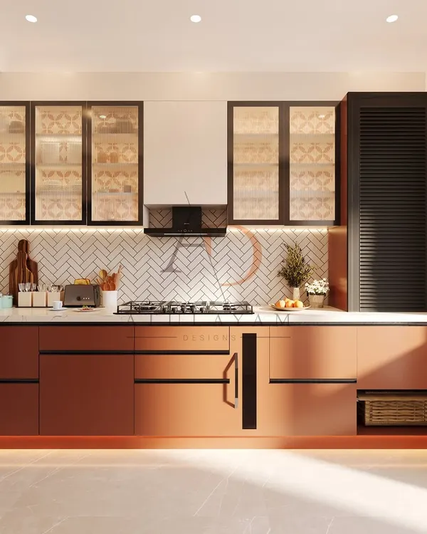 A modern kitchen design featuring a striking combination of rust-toned lower cabinets and glass-front upper cabinets. The herringbone tile backsplash and under-cabinet lighting add texture and warmth, while the layout is optimized for cooking and prep work.
