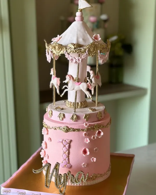 A fairytale on a cake stand. Our carousel cakes, like this one for a first birthday, are a spinning delight of sweetness and sparkle, featuring handcrafted horses and intricate details.