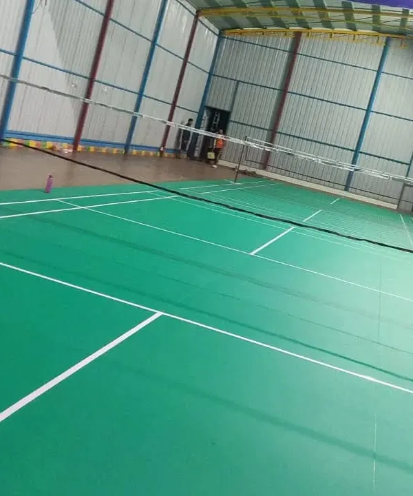 A clear view of one of our professional-grade indoor badminton courts. The space is well-lit with high ceilings and proper flooring, ready for training and matches.