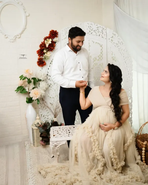 A beautiful moment between the expecting couple in my boho setup. The soft, neutral tones and natural textures create a warm and inviting atmosphere.