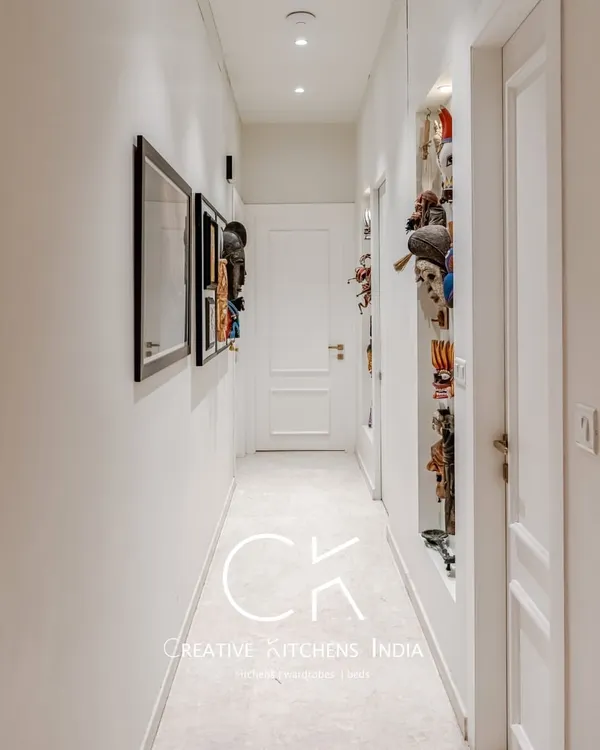 Hallways are the perfect canvas for personal expression. Here, we used thoughtful lighting and curated art pieces to transform a simple corridor into a striking visual gallery that sets the tone for the entire home.