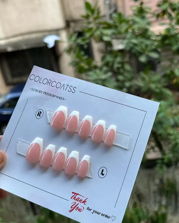 The quintessential classic French manicure. This custom press-on set features a clean, crisp white tip on a natural pink base, shaped into a sophisticated medium coffin style.