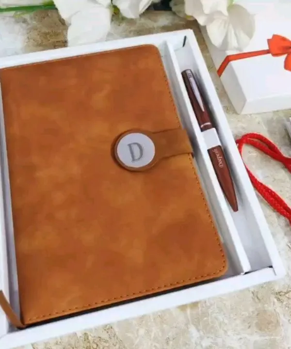 This is my premium diary and pen combo in a warm Camel Brown faux leather. The diary features a magnetic clasp with a custom initial, and it comes with a matching personalized pen in a white gift box.