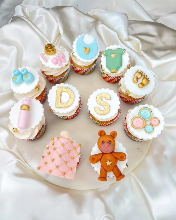 Welcoming a little one is such a special time. We created this set of custom baby shower cupcakes with adorable, handcrafted fondant toppers, including initials, teddy bears, booties, and baby bottles.